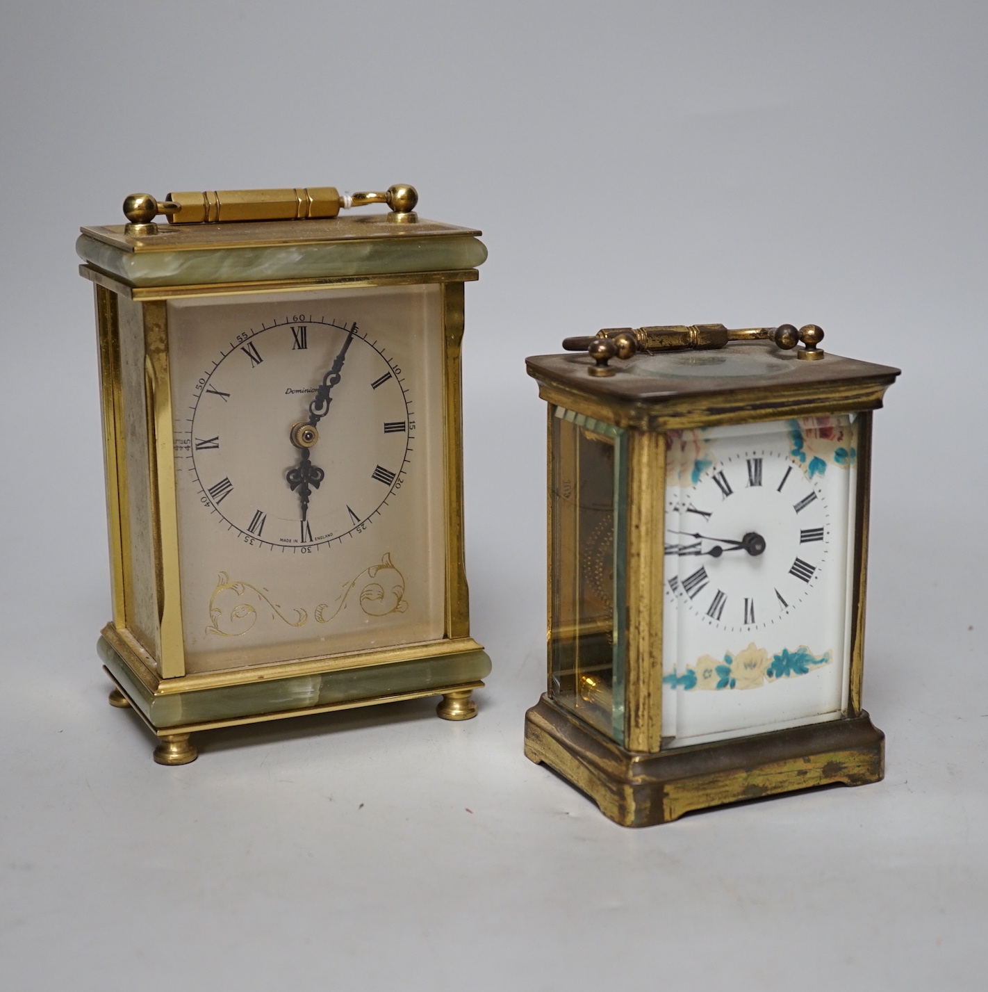 Two carriage timepieces comprising a brass example and one green onyx mounted with quartz movement, largest 17cm high
